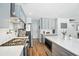 Well-lit kitchen featuring stainless steel appliances, light gray cabinets, and bright quartz countertops at 7164 Sweetgrass Blvd, Hanahan, SC 29410