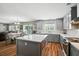 Open kitchen and dining area with gray cabinetry, quartz countertops, and stainless steel appliances at 7164 Sweetgrass Blvd, Hanahan, SC 29410