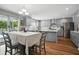 Bright and airy kitchen and dining area featuring gray cabinets, stainless steel appliances, and a chandelier at 7164 Sweetgrass Blvd, Hanahan, SC 29410