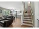 Open-concept living space with staircase and kitchen area, perfect for modern living at 7164 Sweetgrass Blvd, Hanahan, SC 29410