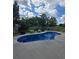 A refreshing in-ground pool with a concrete border and lush landscaping offers a private oasis for enjoyment at 7164 Sweetgrass Blvd, Hanahan, SC 29410