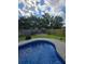 Backyard featuring an in-ground pool and a cozy fire pit seating area for outdoor relaxation and entertaining at 7164 Sweetgrass Blvd, Hanahan, SC 29410