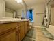 Bathroom featuring a shower, tub, vanity, and blue and green accents at 7277 Sweetgrass Blvd, Hanahan, SC 29410