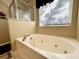 Bathroom featuring large tub, natural light from window, and tile flooring at 7277 Sweetgrass Blvd, Hanahan, SC 29410