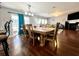 Open dining area with hardwood floors, backyard access, and stylish furnishings at 7277 Sweetgrass Blvd, Hanahan, SC 29410