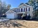 Charming two-story home with gray siding, red shutters, two car garage, and a well-maintained front lawn at 7277 Sweetgrass Blvd, Hanahan, SC 29410