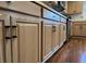 Charming kitchen cabinets with brass hardware and wooden floor at 7277 Sweetgrass Blvd, Hanahan, SC 29410
