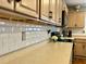 Stylish kitchen counter with white backsplash and wooden cabinets at 7277 Sweetgrass Blvd, Hanahan, SC 29410