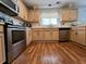 Bright kitchen with stainless steel appliances and warm wood flooring at 7277 Sweetgrass Blvd, Hanahan, SC 29410