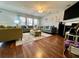 Inviting living room featuring comfortable sofas, hardwood floors, and a cozy fireplace at 7277 Sweetgrass Blvd, Hanahan, SC 29410