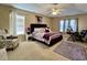 Spacious main bedroom with a tray ceiling, ceiling fan, and comfortable decor at 7277 Sweetgrass Blvd, Hanahan, SC 29410