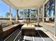 Relaxing screened porch with comfortable seating and views of the wooded backyard at 7277 Sweetgrass Blvd, Hanahan, SC 29410