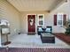 Inviting front porch with seating, decor, and a decorative front door at 7277 Sweetgrass Blvd, Hanahan, SC 29410