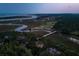 Scenic aerial view captures 79 Trailing Vine near winding rivers, golf course, and the ocean in the distance at 79 Trailing Vine Way, Kiawah Island, SC 29455