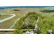 Aerial view showcasing the property surrounded by winding waterways and lush forest at 79 Trailing Vine Way, Kiawah Island, SC 29455
