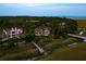Aerial view of 79 Trailing Vine nestled amongst the trees, with a wooden walkway leading to the marshland at 79 Trailing Vine Way, Kiawah Island, SC 29455