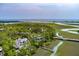 Stunning aerial view of a coastal property with lush trees and waterway access at 79 Trailing Vine Way, Kiawah Island, SC 29455