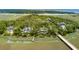 Beautiful aerial view of 79 Trailing Vine surrounded by lush greenery and waterways with private boat dock at 79 Trailing Vine Way, Kiawah Island, SC 29455