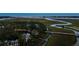 Expansive aerial view showcases 79 Trailing Vine, surrounding marshland, bridges, and the ocean in the distance at 79 Trailing Vine Way, Kiawah Island, SC 29455