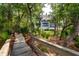 Beautiful backyard with lush landscaping, mature trees, and a view of the home's exterior at 79 Trailing Vine Way, Kiawah Island, SC 29455