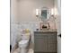 Stylish powder room with marble accents, elegant fixtures, and a unique mirror at 79 Trailing Vine Way, Kiawah Island, SC 29455