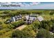 Beautiful aerial view of the Cassique Clubhouse featuring well-manicured landscaping and architectural charm at 79 Trailing Vine Way, Kiawah Island, SC 29455