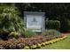Freshfields Village sign surrounded by palm trees, shrubbery and beautiful colorful flowerbed at 79 Trailing Vine Way, Kiawah Island, SC 29455