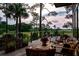 A well-furnished outdoor deck with seating and flowers offers views of trees and marshland beyond at 79 Trailing Vine Way, Kiawah Island, SC 29455