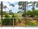 A beautiful view from a deck with cable railing overlooking lush greenery and a marsh at 79 Trailing Vine Way, Kiawah Island, SC 29455