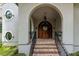 Charming home entrance with brick steps, a wooden door, and elegant architectural details at 79 Trailing Vine Way, Kiawah Island, SC 29455