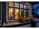 Backyard deck with comfortable seating with warm interior glow seen from large window at 79 Trailing Vine Way, Kiawah Island, SC 29455