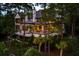 Stunning home with a large porch, dark framed windows, lush landscaping, and inviting outdoor space at 79 Trailing Vine Way, Kiawah Island, SC 29455