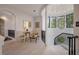 Bright landing featuring light wood floors, white wainscoting, and black iron railings surrounding a stairwell and seating area at 79 Trailing Vine Way, Kiawah Island, SC 29455