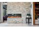 Beautiful living room with a stone fireplace, sleek electric fireplace, and modern furniture at 79 Trailing Vine Way, Kiawah Island, SC 29455