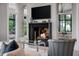Cozy living room features fireplace with mounted tv and view to connected room at 79 Trailing Vine Way, Kiawah Island, SC 29455