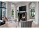 Cozy living room features fireplace with mounted tv and view to connected room at 79 Trailing Vine Way, Kiawah Island, SC 29455