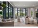 Spacious living room with large windows offering view of outdoor landscape at 79 Trailing Vine Way, Kiawah Island, SC 29455