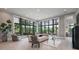 Bright and inviting living room with views to the outdoor landscape through large windows at 79 Trailing Vine Way, Kiawah Island, SC 29455