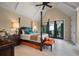 Bright main bedroom featuring a four-poster bed, high ceilings, and private outdoor access at 79 Trailing Vine Way, Kiawah Island, SC 29455