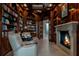 Elegant office with rich wood paneling, built-in bookshelves, and a cozy fireplace at 79 Trailing Vine Way, Kiawah Island, SC 29455
