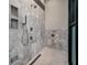 Walk-in shower featuring marble tiling, a rainfall showerhead, and built-in niche shelving at 79 Trailing Vine Way, Kiawah Island, SC 29455