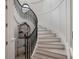 Elegant curved staircase featuring black railings, white walls, and a birdcage decoration at 79 Trailing Vine Way, Kiawah Island, SC 29455