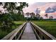 Beautiful walkway towards the water with stunning sunset views and lush green surroundings at 79 Trailing Vine Way, Kiawah Island, SC 29455