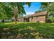 Lush backyard featuring mature trees, a well-manicured lawn, and a screened-in porch, great for relaxation at 8204 Pleasant Ridge Dr, Charleston, SC 29420