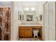 Bathroom with a single vanity, mirrored medicine cabinet, and a shower with decorative curtain at 8204 Pleasant Ridge Dr, Charleston, SC 29420