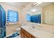 Clean bathroom featuring a single vanity, toilet, and shower-tub combo with blue striped curtain at 8204 Pleasant Ridge Dr, Charleston, SC 29420