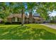 Charming brick home featuring a well-manicured lawn and mature trees for shade at 8204 Pleasant Ridge Dr, Charleston, SC 29420