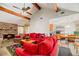 Open-concept living room with exposed beams, brick fireplace, and comfortable seating area at 8204 Pleasant Ridge Dr, Charleston, SC 29420