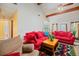 Bright living room featuring a vaulted ceiling, wooden beams, and comfortable red couches at 8204 Pleasant Ridge Dr, Charleston, SC 29420