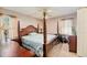 Main bedroom with four-poster bed, neutral carpet, and windows with light-filtering curtains at 8204 Pleasant Ridge Dr, Charleston, SC 29420